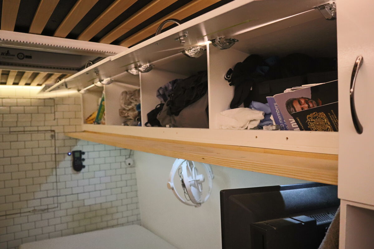 Storage cupboards above the bed